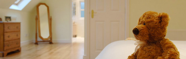 Teddy bear on bed in loft conversion